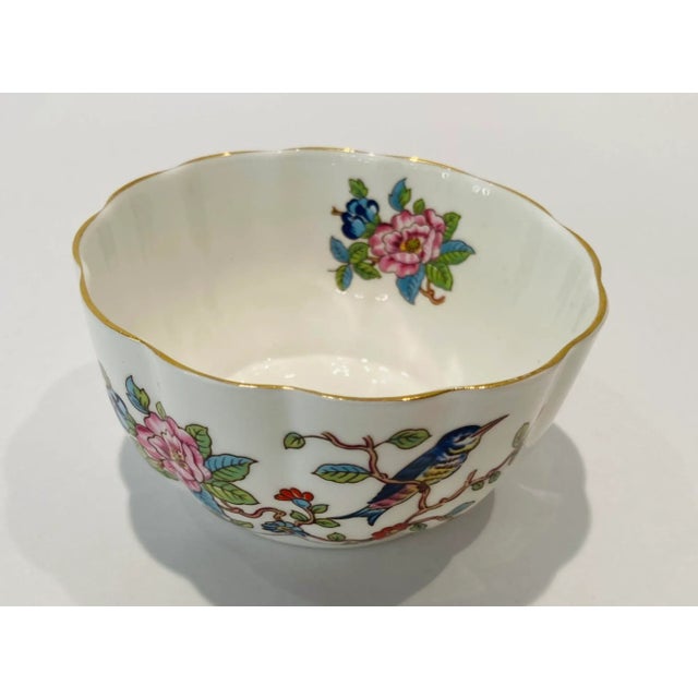 Aynsley bone china bowl finely designed with the Pembroke pattern with gold trim with a bright cobalt blue bird perched on...
