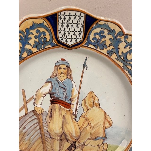 A good 1950's French Quimper Faience plate depicting two fishermen, with soft color. In good condition with minor wear....