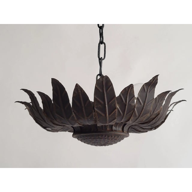 A very decorative mid-century wall or ceiling light made of embossed sheet metal in the shape of a sunflower. Light signs...