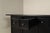 The large cabinet is built as a strongly horizontal composition, with four wide drawers above four substantial panelled...