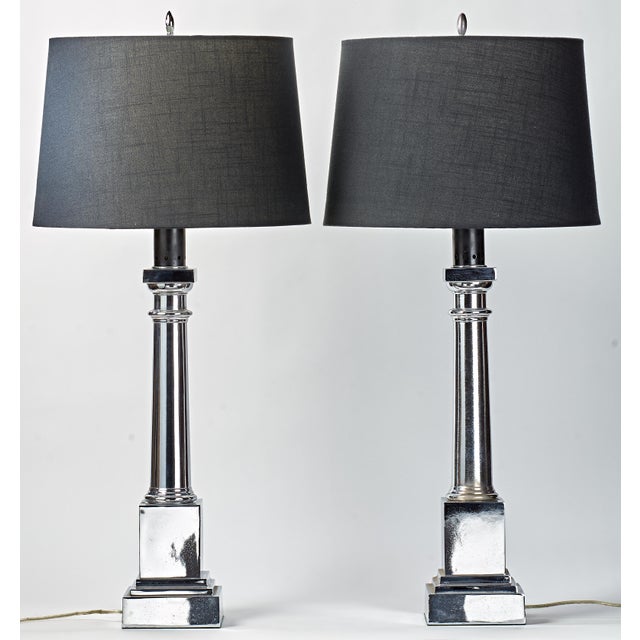 Chrome plating over metal. These lamps have weight and heft, very substantial. They make a statement with the classic...