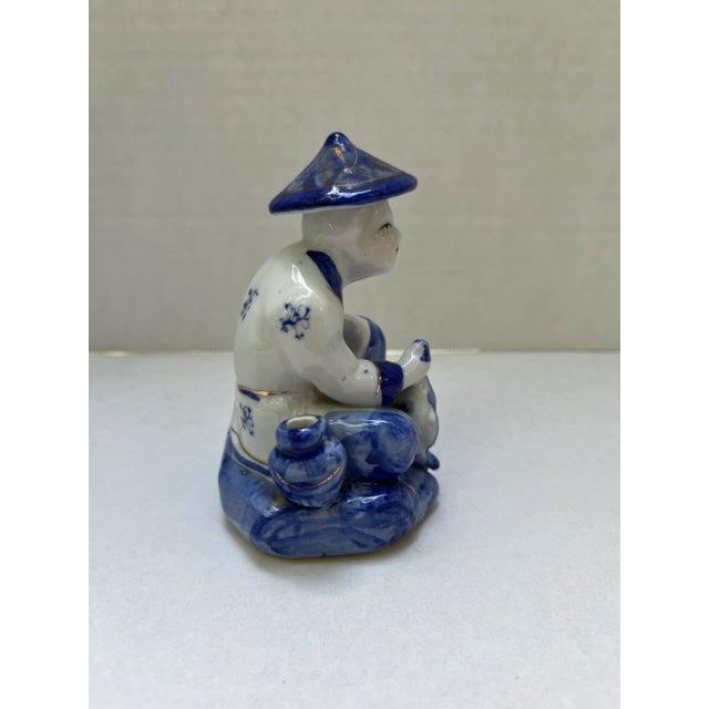 Small Chinese blue and white porcelain figure of a fisherman with hand painted blue and gold decoration. Perfect size for...