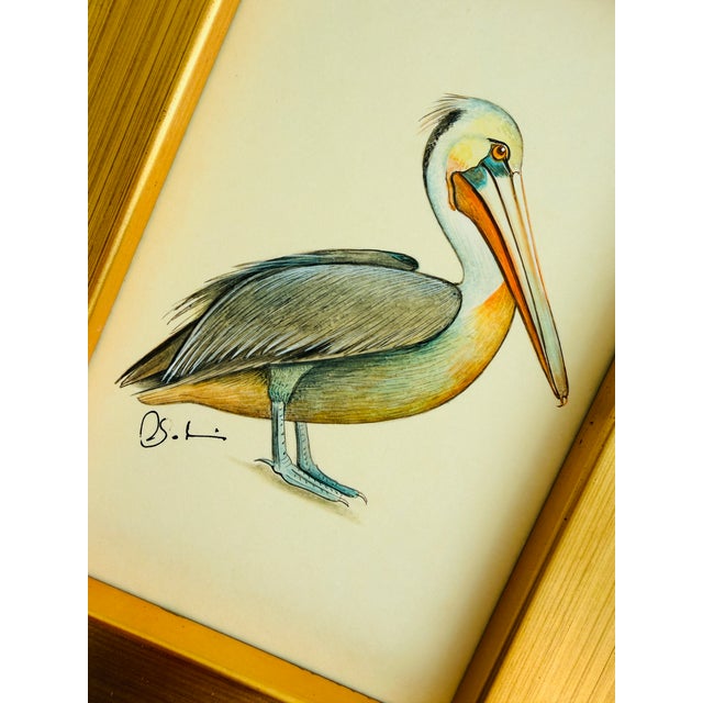 This striking pelican is hand-painted by master artists using acrylic paints and natural pigments, with extraordinary...
