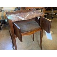 This 19th-century French chevet table is a charming example of the period's fine craftsmanship and elegant design. Crafted...