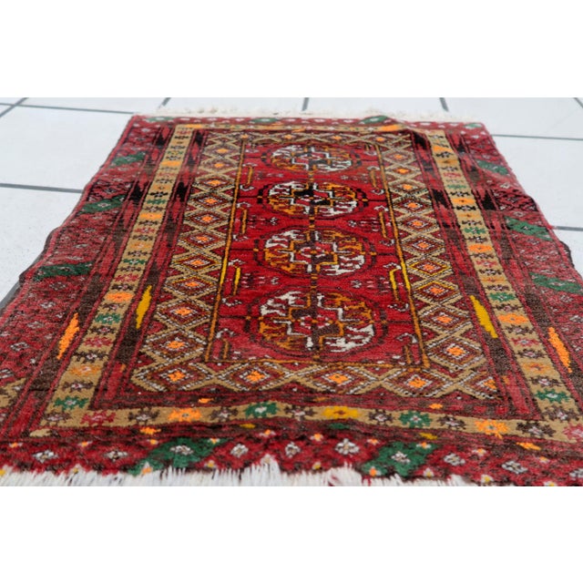 Add a touch of elegance and heritage to your space with our Handmade Vintage Afghan Ersari Mat from the 1960s. Crafted...