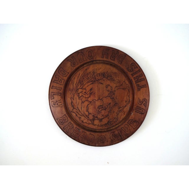 An antique round wooden bread board, carved with a late-nineteenth century, Art Nouveau design of poppies and wheat in the...