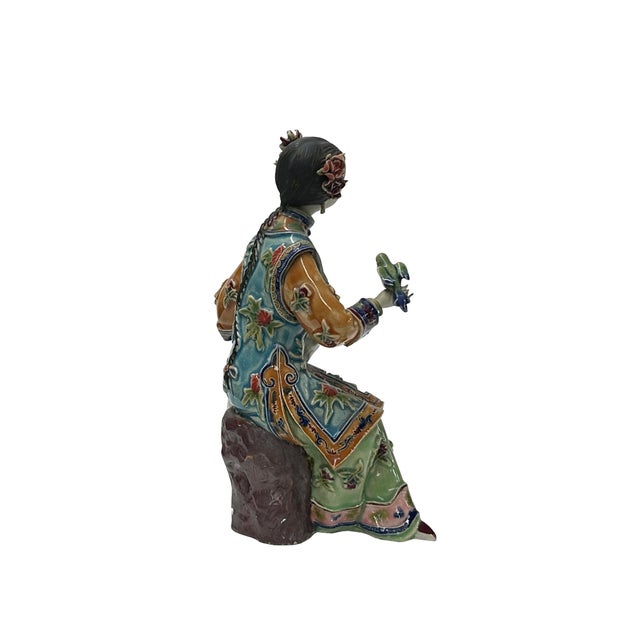 This Chinese Qing style dressing lady figurine is a beautiful and delicate piece of art. It is made of ceramic pottery and...