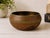 A richly detailed vintage Indian brass bowl featuring hand-etched floral and foliate motifs highlighted with red and black...