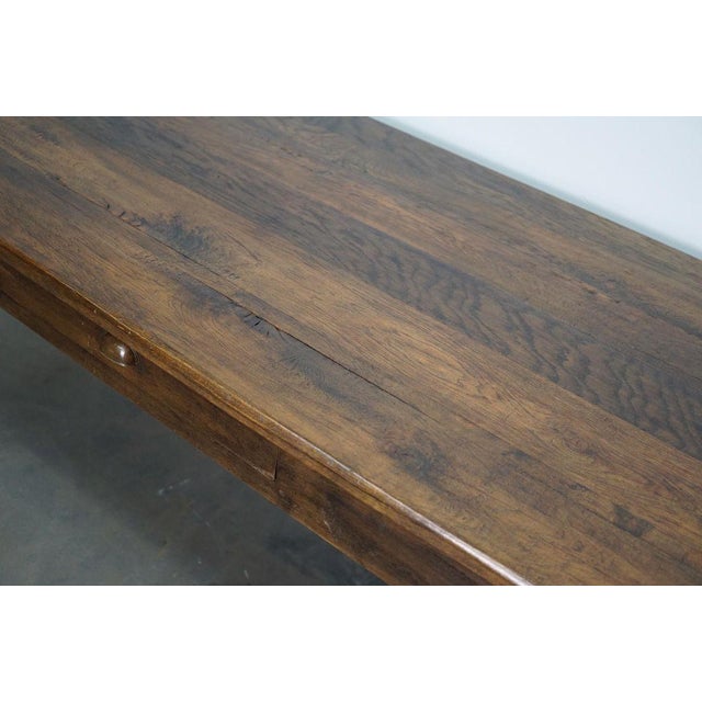 This antique French table was made from oak in the late 19th century. The table was made a few centimeters higher, to...