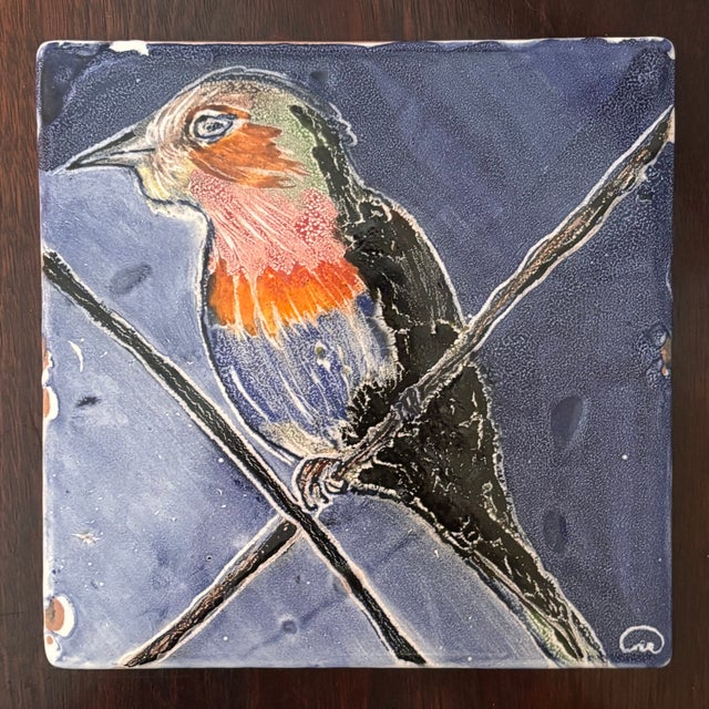 Offering a beautiful vintage hand painted ceramic art tile featuring a colorful songbird perched among branches against a...