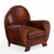 An early 20th-century Dutch leather club chair with matching ottoman in the Art Deco style. The chair features a rounded...