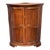 A French corner cabinet in walnut, the bowed front with a pair of shaped panel doors centered by a pierced brass...