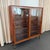 This Danish Mid-Century Modern rosewood display cabinet bookcase was designed by Poul Hundevad circa 1960s. The cabinet...