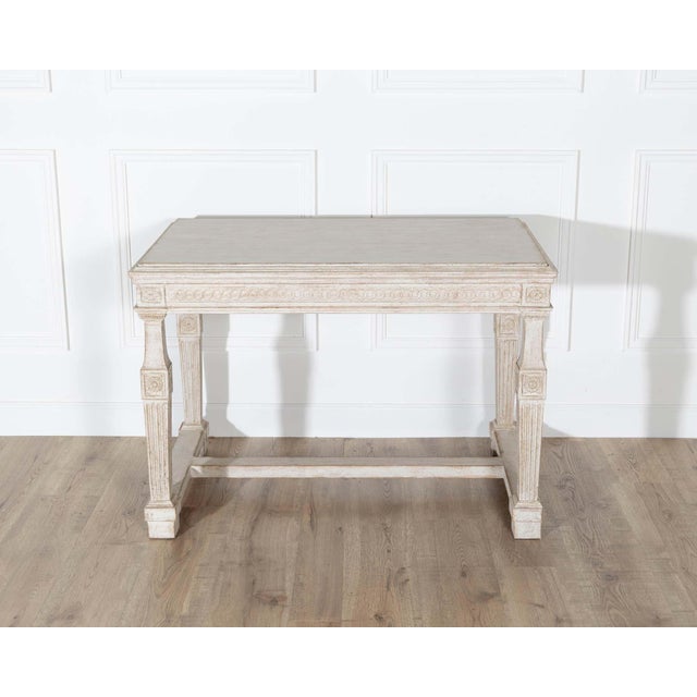 An elegant Swedish Gustavian console table from the first quarter of the 1800s, masterfully crafted in carved pine and...