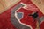 A 3rd quarter of the 20th-century Chinese rug with a dragon motif on a dark red field Size: 4' x 7''.