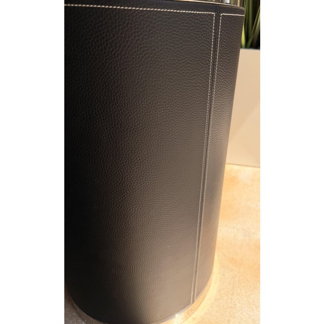 Add a touch of refined sophistication to your space with this contemporary round end table, wrapped in richly textured...