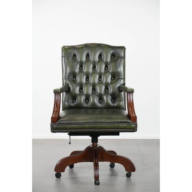 We are offering this beautiful and timeless dark green cowhide leather and wooden Chesterfield office chair in English...