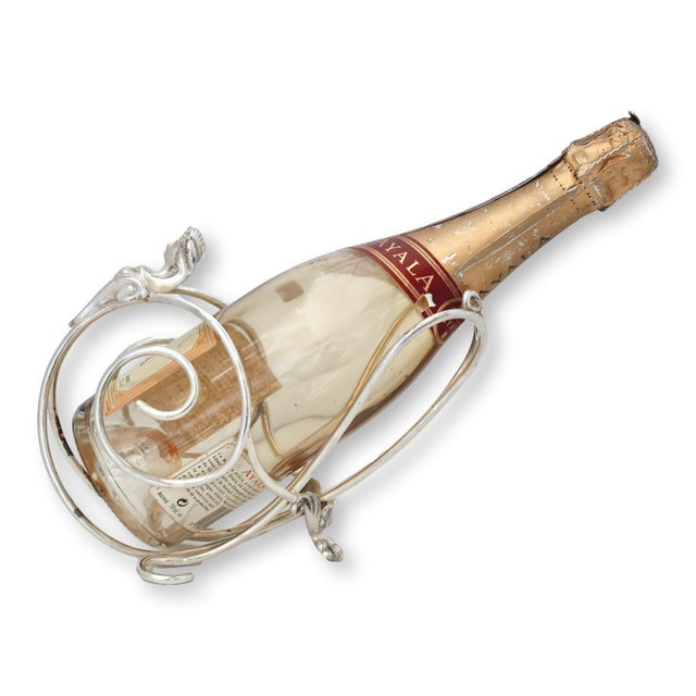 An unusual English silverplate wine pourer attributed to Elkington's celebrated Sphinx design. The sculptural frame...
