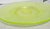 Hand blown round plate having a vaseline uranium green tone with iridescent vitriol. Pontil mark seen to bottom. Measures...