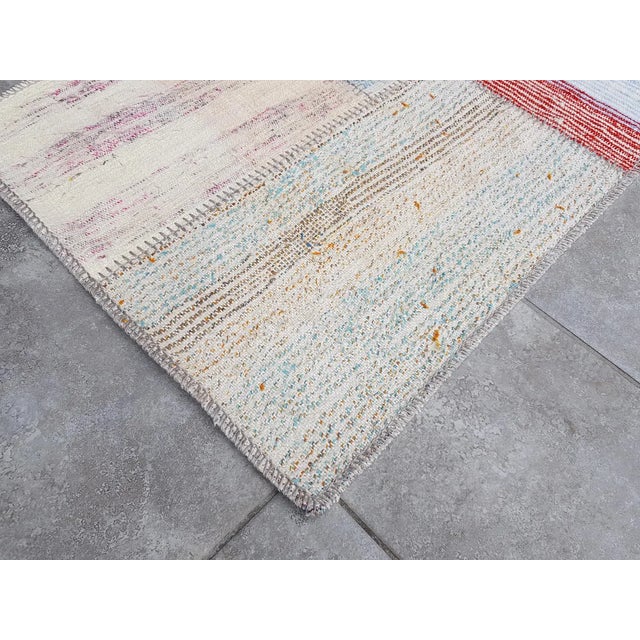 This is a vintage Turkish Oushak rug from the Mid 20th Century. The piece was hand-knotted.