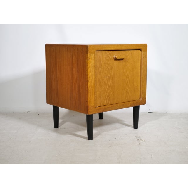 Compact mid-century cube chest of drawers in teak by Dyrlund, 1970s. The cubic body features softly rounded edges, a solid...