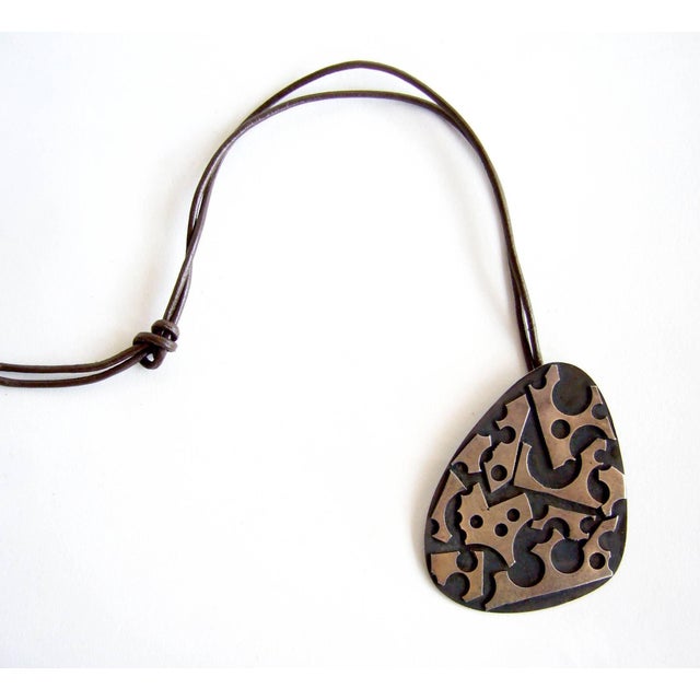 Oxidized sterling silver pendant created by silversmith James Parker of San Diego, California. Parker was an early member...