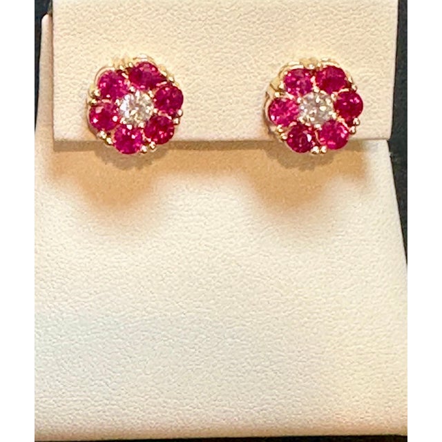 A sweet, shimmery style for any day of the week. These stud earrings blossom floral clusters of 3 ct. t.w. round...