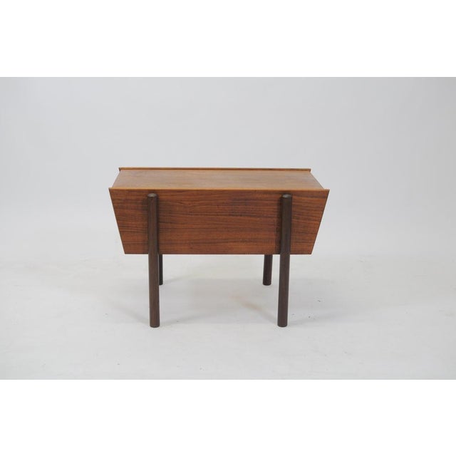 Danish 1960s sewing table in teak with sliding table top and large compartment under the table top by a Danish furniture...