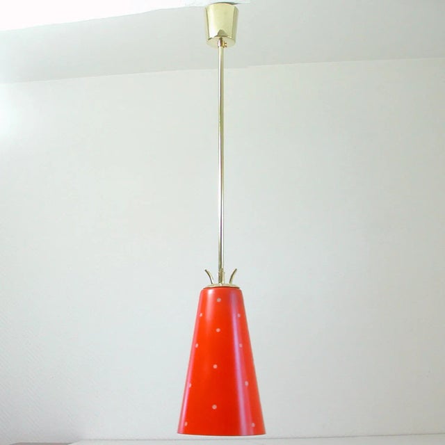 This unusual pendant was manufactured in sweden in the 1950s. It is made of brass and has got a red and white (dotted)...