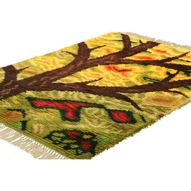 Hand-knotted in lush, high-pile wool in Sweden circa 1960-1970, this 5x7 vintage Swedish Rya rug is a bold new addition to...