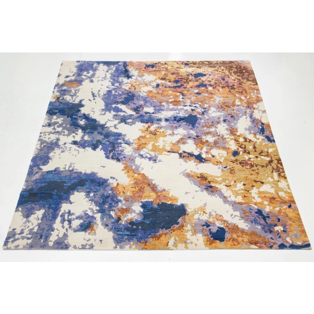 This contemporary hand-knotted rug features a striking abstract design in vibrant colors that effortlessly captures...
