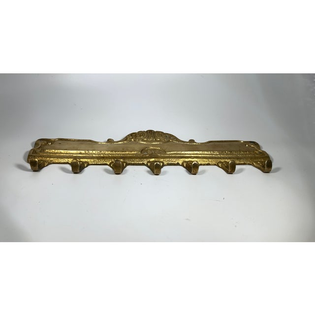 This solid brass wall mounted hook plate has 7 hooks, great for keys and other small items. Pretty decorative scrolling...