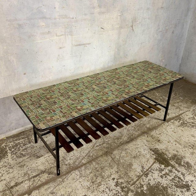 A distinctive mid-century modern coffee table featuring a colourful mosaic-effect Formica top, slender black metal frame...