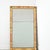 This French Empire mantle mirror (early 1800s) exhibits restrained surface decoration concentrated to intermittent, low-...