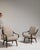 Here is a pair of armchairs, its taupe upholstery, dark wood angled legs the first thing to catch the eye. Originating in...