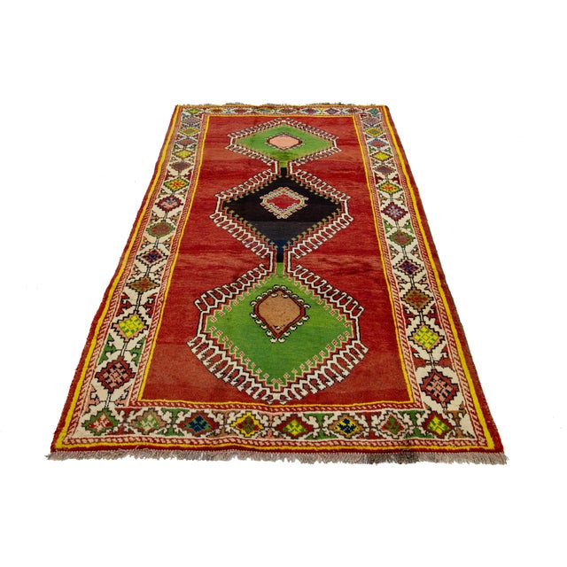 Beautiful vintage Shiraz Handmade Wool rug with a red field and multicolor accents allover the tribal pattern. This rug...