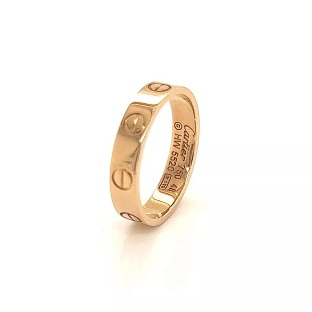 This is an elegant authentic band ring by Cartier from the LOVE collection in the mini style. It is crafted from solid 18k...