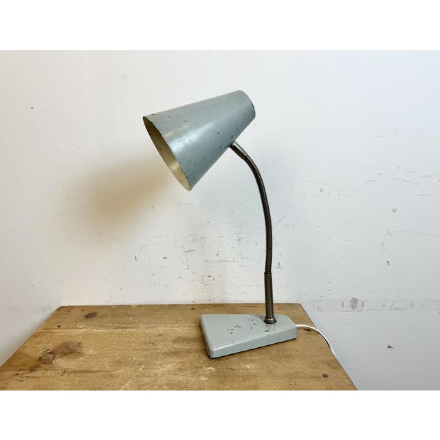 Industrial workshop table lamp made by Zaos in Poland during the 1960s.It features a grey metal base and shade and a...