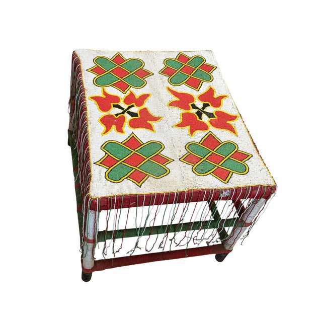 A striking handcrafted Yoruba nobility table from Nigeria, featuring a solid wood base adorned with vibrant trade glass...