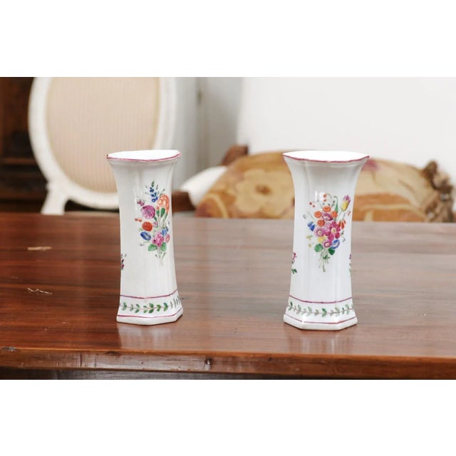 A pair of Italian porcelain vases from the early 19th century, with painted floral decor. Created in Italy during the...