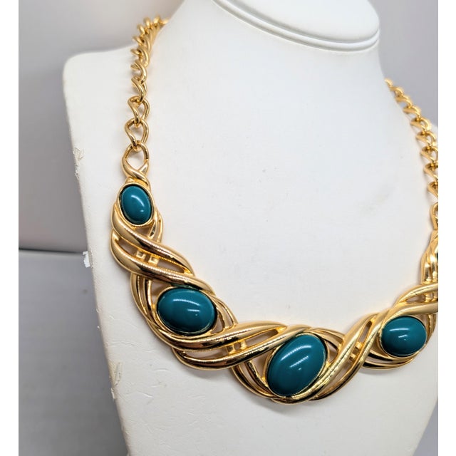 1990s goldtone 5 cabochon faux-green jasper collar necklace with hook clasp. Marked "©Monet" on the back of the center...