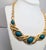 1990s goldtone 5 cabochon faux-green jasper collar necklace with hook clasp. Marked "©Monet" on the back of the center...