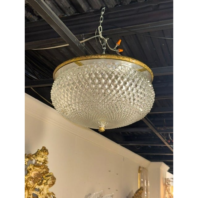 The French Cut Glass and Gilt Brass Flush Mount Chandelier is a sophisticated and elegant lighting fixture that brings a...