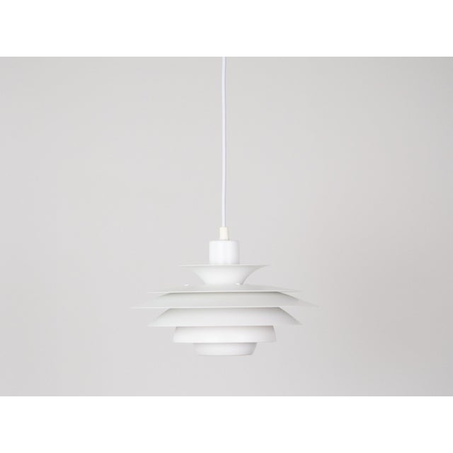 This lamp was designed by Danish designer Kurt Wiborg and manufactured by Jeka. The lamp's form is based on the principle...