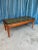 An elegant Italian neoclassical coffee table from the 1940s, distinguished by its richly carved mahogany base and...