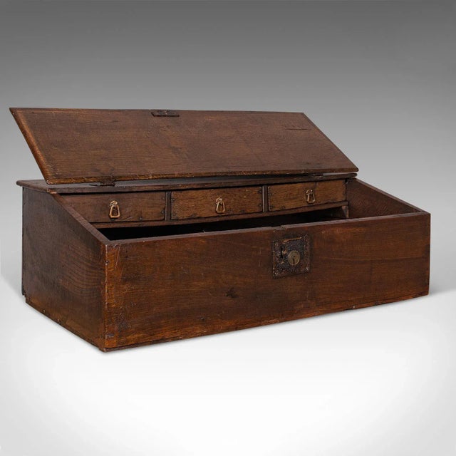 This is an antique verger's table top desk. An English, oak ecclesiastical writing table, dating to the William III...
