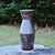 Angled stoneware vase, wheel-thrown from speckled stoneware and hand-painted with "Acai Matte Shino" glaze. Brand: Hiraeth...