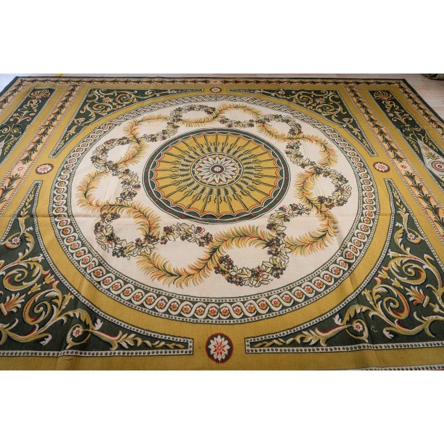 Vintage Aubusson in the grand Empire style. A great round medallion with a sunburst rosette at its centre is ringed by...
