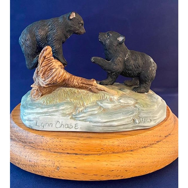 Hard-to-find ceramic music box on oak base by artist Lynn Chase. Plays "Tales from the Vienna Woods." Lynn Chase Designs...