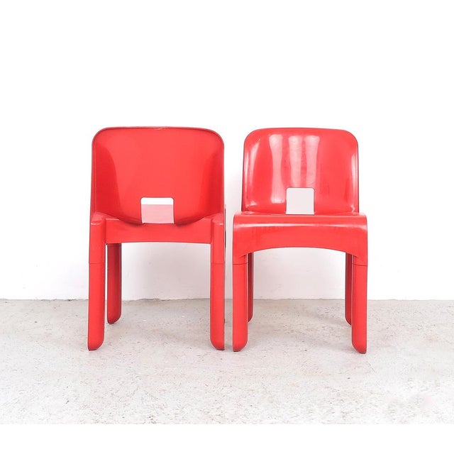 Set of 2 universale red plastic stacking chairs produced by kartell italy, 1960s designed by joe colombo. dimensions:...
